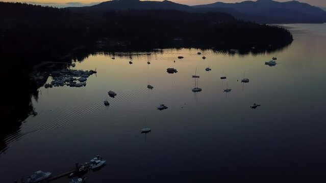 Beautiful Sechelt Inlet With Anchorages At Dusk In Sunshine Coast, British Columbia, Canada. Aerial Pullback Shot