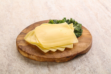 Sliced Gouda cheese over board