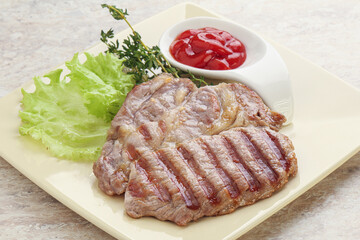 Grilled pork neck steak with ketchup