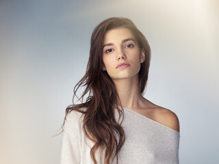 Gorgeous and graceful. Studio shot of a beautiful young woman posing against a gray background.