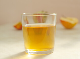 a glass of apple juice on the background of apples.