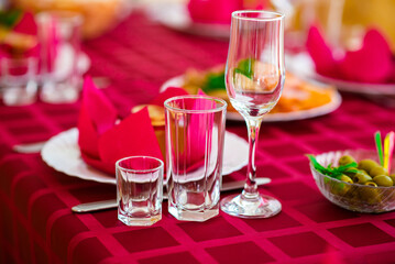 Christmas decorated table for the holidays with a candle and marshmallows, Christmas tree and red tablecloth