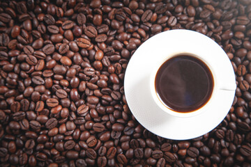 Cup of coffee on coffee beans.