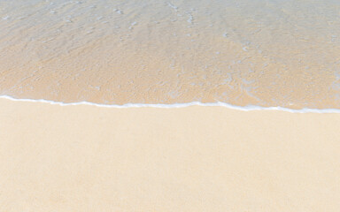 Blank fine sandy beach with clean sea water wave background, tropical nature background, summer season