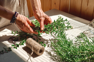 Alternative medicine. Woman holding in her hands a bunch of marjoram. Herbalist woman preparing fresh scented organic herbs for natural herbal methods of treatment. - obrazy, fototapety, plakaty