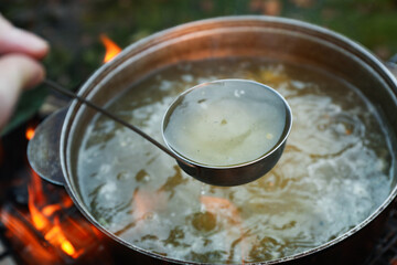 Concept of cooking soup on the fire