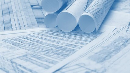 Background on the theme of business in the field of construction and architecture. Sheets with drawings and sketches of a glass skyscraper in soft focus.