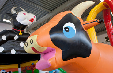 Inflatable bouncy castles. Inflatables. Plastic cow. 