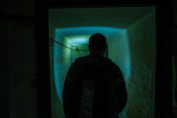 boy walks in an underground bunker