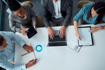 Forecasting the best for their business. High angle shot of a group of businesspeople having a...