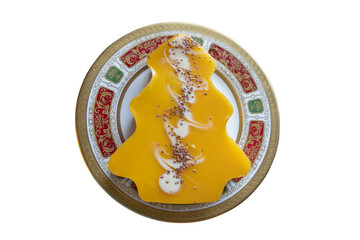 Mango cheesecake in the shape of a Christmas tree  used as a Christmas pudding dessert served at dinner time on Christmas day or Boxing Day during the festive season in December stock photo image