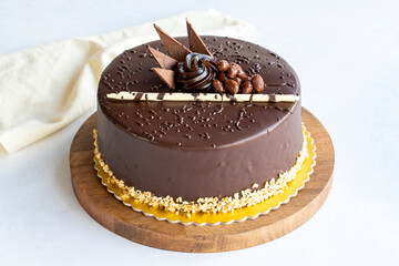 Chocolate birthday cake on a white background. Cake with croquant and cream filling. Bakery products. close up