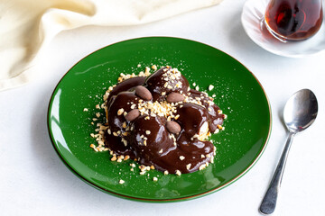 Profiterole on a white background. Profiterole filled with milk cream. Bakery products. close up