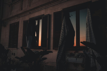 sunset reflections in the windows of a historic house