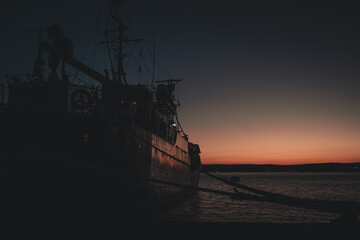 fishing boat in the harbour at sunset