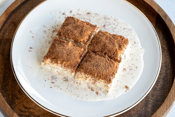 Cold baklava on a white background. Baklava with pistachio milk. Traditional Turkish cuisine delicacies. The new trend is baklava. close-up. local name soguk baklava