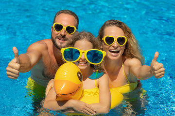 Happy family in outdoor pool - 498474511