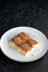 Cold baklava on a dark background. Baklava with pistachio milk. Traditional Turkish cuisine delicacies. The new trend is baklava. close-up. local name soguk baklava