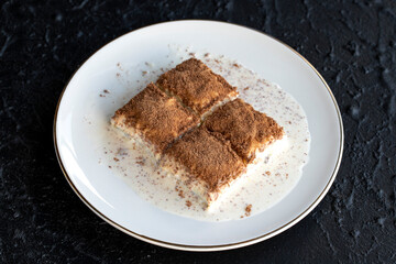 Cold baklava on a dark background. Baklava with pistachio milk. Traditional Turkish cuisine delicacies. The new trend is baklava. close-up. local name soguk baklava