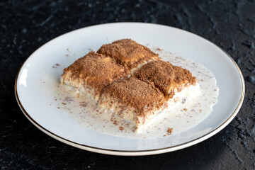 Cold baklava on a dark background. Baklava with pistachio milk. Traditional Turkish cuisine delicacies. The new trend is baklava. close-up. local name soguk baklava