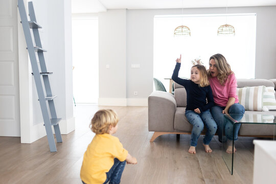 Mother with children playing in living room