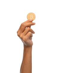 cryptocurrency, finance and business concept - close up of female hand holding golden bitcoin over...