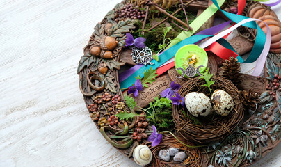 Wiccan altar for Beltane sabbath. spring pagan festive ritual. wheel of the year, nest with eggs,...