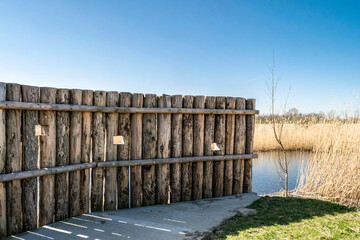 Wooden log wall for birdwatching in Almere Kromslootpark, Netherlands. 