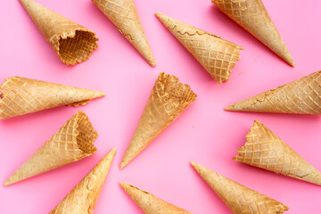 Empty ice cream cone on pink background.