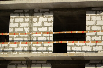 Construction of residential building. Wall of unfinished building. Construction details. Preparation of walls for cladding.