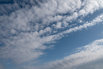 White fluffy clouds on blue sky. Nature background.