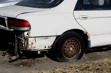 rusty abandoned car with flat wheels