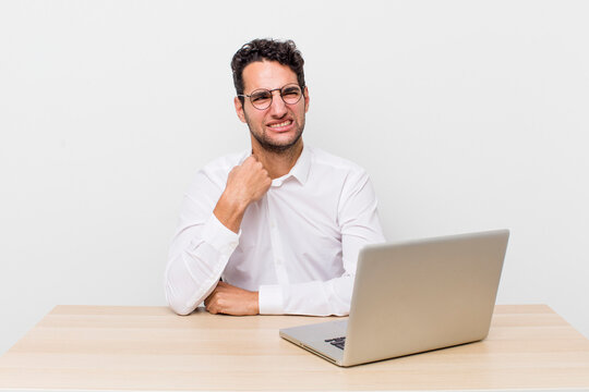 hispanic handsome man feeling stressed, anxious, tired and frustrated. businessman and desk concept