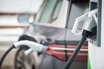Electric Car Charging. Charger connector plugged to Electric auto