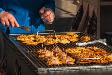 Natural traditional street food, smoke and steam over food, meat, close-up of counter, grill, barbecue outdoors, Old Town in Krakow, Poland