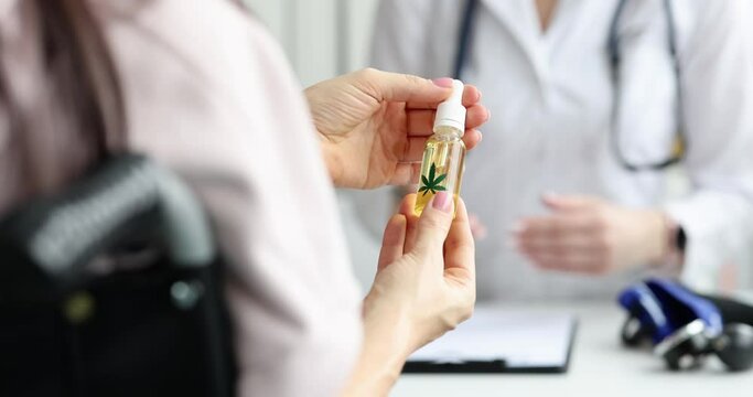 Patient holding marijuana oil at doctor appointment