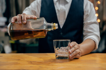 Barman pouring whiskey whiskey glass beautiful night