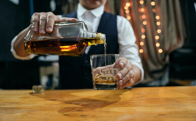 Barman pouring whiskey whiskey glass beautiful night
