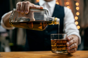 Barman pouring whiskey whiskey glass beautiful night