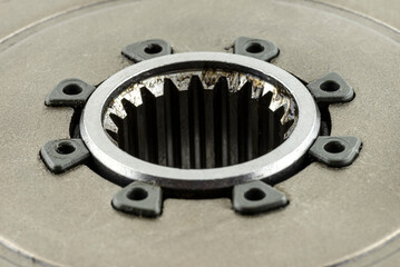 Macro photo of a gear shaft socket of a used automotive clutch.