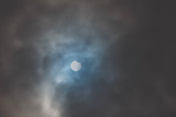 Fototapeta na wymiar Solar Eclipse. Partial phase on a cloudy day.