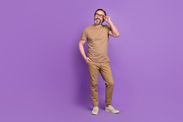 Fototapeta premium Full body profile side photo of aged man hold laptop go representative wear modern outfit isolated over violet color background
