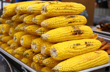 Baked corn at the fair, street food. Healthy food.