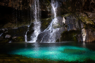 Fototapeta na wymiar Alpine Waterfall with Green lagoon in Beautiful Autumn Season - Waterfall Virje - Bovec, Slovenija