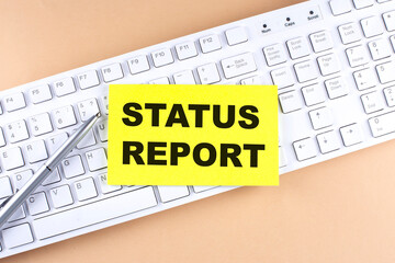 Text STATUS REPORT text on a sticky on keyboard, business concept