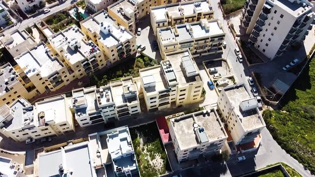 Residential building of coastal town in Malta island. Aerial tilt up view