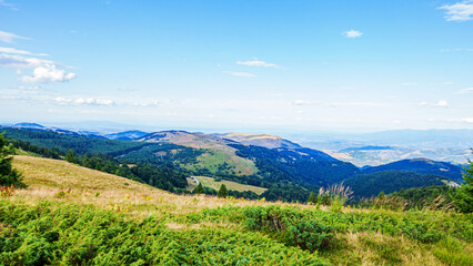 Fototapeta na wymiar Visually Attractive View of Summer Countryside Mountain Nature Landscape. Picturesque Scenery Green Hills And Fields. Beautiful Blue Sky With Clouds. Mountain Kopaonik, Serbia, Europe.