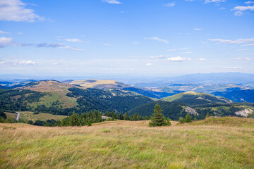 Fototapeta na wymiar Summer Countryside Mountain Nature Landscape. Picturesque Scenery Green Hills And Fields. Beautiful Blue Sky With Clouds. Visually attractive View Of Mountain Kopaonik, Serbia, Europe.