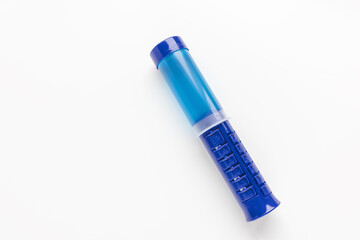 Fresh toilet cleaner gel on white background. Blue stamp wc cleaning dispenser. Closeup, copy space