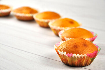 Homemade cupcakes on wooden table.
